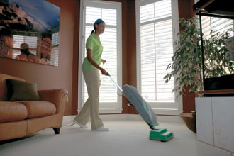Merry Maids house cleaner vacuuming